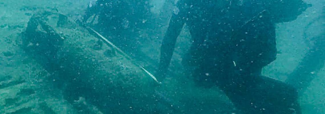 EODD officers dive under sea to measure the bomb